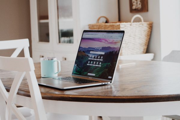 open layptop on table with coffee