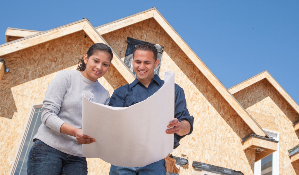 Couple in front of new built home