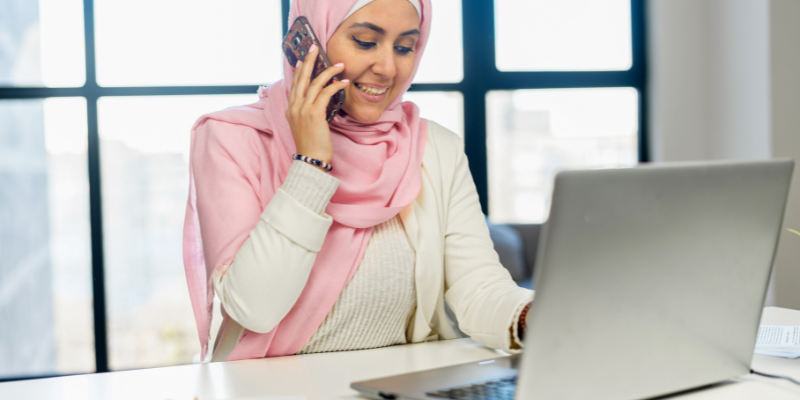 women on phone with computer women on phone with computer
